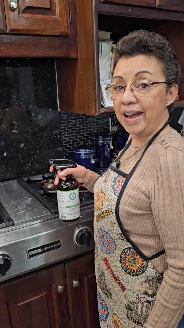 Dora Garcia using Natural Choice cleaner in her kitchen
