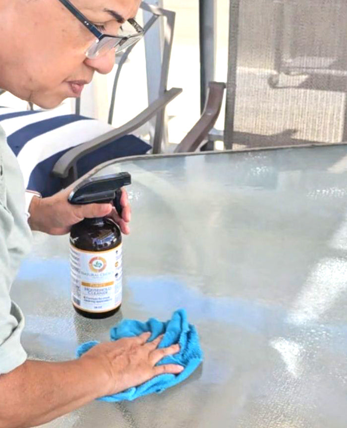 Natural Choice cleaner being used on a glass table