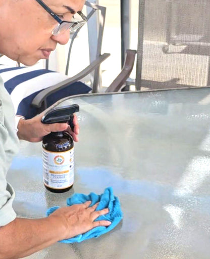 Natural Choice cleaner being used on a glass table